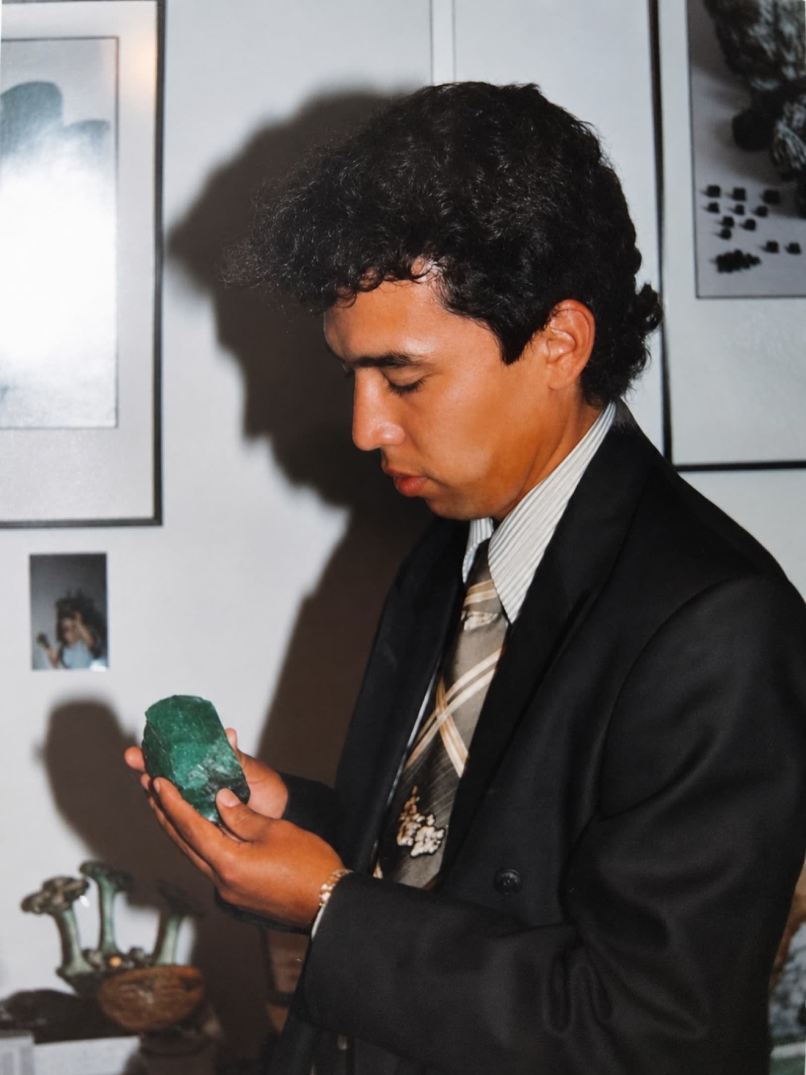 A young Darwin Sandoval examining a large rough emerald, Bogotá, early 1990s